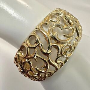 Gold tone cut out hinged bangle bracelet